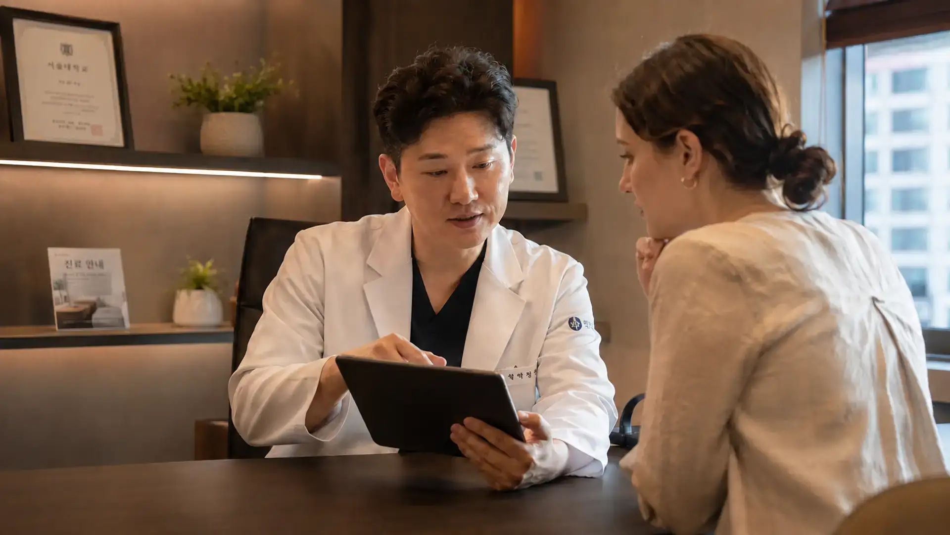 Visitor asking doctor credential questions to verify a Korean clinic before treatment